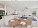 Bright, open-concept living space featuring a dining table, a living room area with large window, and neutral decor at 2171 Portofino Pl # 27-2725, Palm Harbor, FL 34683