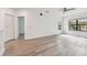 Bright living area with wood floors, white walls, a ceiling fan, a large window, and a closet at 2171 Portofino Pl # 27-2725, Palm Harbor, FL 34683