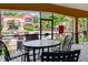 A serene screened patio with comfortable seating overlooks a vibrant pool and beautifully landscaped courtyard at 2171 Portofino Pl # 27-2725, Palm Harbor, FL 34683