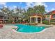 Community pool featuring a waterfall and covered gazebo with lounge seating at 2171 Portofino Pl # 27-2725, Palm Harbor, FL 34683