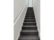 Carpeted staircase with white handrail leading to the upper level at 2171 Portofino Pl # 27-2725, Palm Harbor, FL 34683