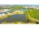 Scenic aerial view of homes nestled among lush greenery, lakes and winding waterways at 2211 Harrison Dr, Holiday, FL 34691