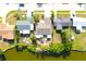 Aerial view of a home with a private dock on the water, lush landscaping, and well-maintained surroundings at 2211 Harrison Dr, Holiday, FL 34691