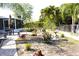 Large backyard featuring mature landscaping, stone statues, and space for outdoor enjoyment at 2211 Harrison Dr, Holiday, FL 34691