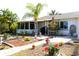 Spacious backyard featuring mature landscaping, brick pavers, and space for outdoor enjoyment at 2211 Harrison Dr, Holiday, FL 34691