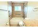 Clean bathroom featuring a tiled shower and granite vanity top with a window and grab bars at 2211 Harrison Dr, Holiday, FL 34691