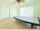 Bedroom featuring tile floors, ceiling fan, sliding door and ample closet space at 2211 Harrison Dr, Holiday, FL 34691