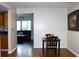 Cozy dining room with hardwood floors, a dining table and chairs next to the opening to the living room at 2211 Harrison Dr, Holiday, FL 34691