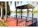 Waterfront property with private wooden dock overlooking serene lake, perfect for relaxing at 2211 Harrison Dr, Holiday, FL 34691