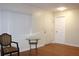 Bright entryway with a window, a glass-topped table, a chair, and a white door at 2211 Harrison Dr, Holiday, FL 34691