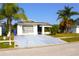 Lovely single-story home featuring mature trees, well-maintained landscaping, and a spacious driveway at 2211 Harrison Dr, Holiday, FL 34691