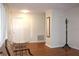 Entry hall featuring clean design, a door, and a striking coat rack on stylish hardwood floors at 2211 Harrison Dr, Holiday, FL 34691