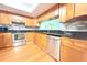 Kitchen featuring stainless steel appliances, wood cabinets, and a view into another room at 2211 Harrison Dr, Holiday, FL 34691