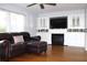 Spacious living room boasts custom built-ins, a cozy fireplace, and a comfortable leather sectional at 2211 Harrison Dr, Holiday, FL 34691
