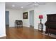 Open-concept living area showcases a piano, dining set and modern lighting, creating a seamless flow at 2211 Harrison Dr, Holiday, FL 34691