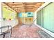 Inviting outdoor patio area with a hammock, seating, and painted mural for relaxation at 2211 Harrison Dr, Holiday, FL 34691
