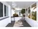 Relaxing screened porch with comfortable seating, ceiling fan, and serene outdoor views at 2211 Harrison Dr, Holiday, FL 34691