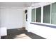 Cozy screened porch featuring tile flooring, a ceiling fan, and outdoor access at 2211 Harrison Dr, Holiday, FL 34691