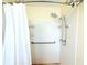 Updated bathroom shower with handrails and tile surround at 2211 Harrison Dr, Holiday, FL 34691