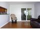 Cozy sitting area next to sliding glass doors, with views to the lanai and kitchen in the background at 2211 Harrison Dr, Holiday, FL 34691