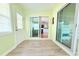 Bright sunroom featuring wood-look floors, sliding glass doors, and natural light at 2211 Harrison Dr, Holiday, FL 34691