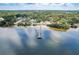 Aerial view of a private dock stretching into the serene water and surrounding community at 224 Georgia Ave, Crystal Beach, FL 34681