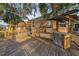 Lovely back deck with bar and palm trees great for entertaining or relaxing outdoors at 224 Georgia Ave, Crystal Beach, FL 34681
