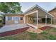 Backyard with covered carport, accented with a colorful rock border at 224 Georgia Ave, Crystal Beach, FL 34681