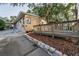 A spacious backyard boasts a deck with a wooden railing, brick trim and manicured landscaping at 224 Georgia Ave, Crystal Beach, FL 34681