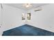 Bright bedroom with blue carpeting, mini-split AC, ceiling fan and double window for natural light at 224 Georgia Ave, Crystal Beach, FL 34681