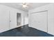 Bedroom featuring blue carpeting, a ceiling fan, closet space and a doorway leading to another room at 224 Georgia Ave, Crystal Beach, FL 34681