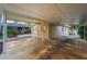 Spacious covered carport area, offering ample parking and shelter, adjacent to a beautifully landscaped yard at 224 Georgia Ave, Crystal Beach, FL 34681
