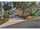Landscaped front yard with a well-maintained lawn and mature trees providing plenty of shade at 224 Georgia Ave, Crystal Beach, FL 34681