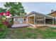 Charming single-story home with a covered carport and meticulously landscaped front yard featuring vibrant flowering shrubs at 224 Georgia Ave, Crystal Beach, FL 34681
