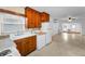Galley kitchen open to the living space with wood cabinets and bright natural light at 224 Georgia Ave, Crystal Beach, FL 34681