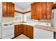 This galley kitchen features classic wood cabinets and white appliances, creating a clean space at 224 Georgia Ave, Crystal Beach, FL 34681