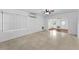 Spacious living room with a ceiling fan, air conditioning unit, and large window providing natural light at 224 Georgia Ave, Crystal Beach, FL 34681