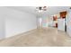 Open-concept living room and kitchen featuring ceiling fan and tile flooring at 224 Georgia Ave, Crystal Beach, FL 34681