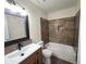 Well-lit bathroom featuring a single sink vanity and a tiled bathtub with a shower at 2302 Maki Rd # 2, Plant City, FL 33563