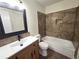Well-lit bathroom featuring a single sink vanity and a tiled bathtub with a shower at 2302 Maki Rd # 2, Plant City, FL 33563