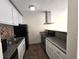Updated kitchen features stainless steel appliances, white cabinets, and modern countertops at 2302 Maki Rd # 2, Plant City, FL 33563
