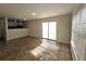 Open-concept living room featuring tiled floors and a sliding glass door to the outside at 2302 Maki Rd # 2, Plant City, FL 33563