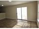 Bright, empty living room featuring neutral paint, tile floors, and sliding glass doors leading to a patio at 2302 Maki Rd # 2, Plant City, FL 33563