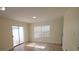 Bright living room with a sliding glass door and tile flooring throughout at 2302 Maki Rd # 2, Plant City, FL 33563
