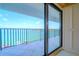 Balcony with waterfront views through sliding glass doors and metal railing at 240 Sand Key Estates Dr # 243, Clearwater Beach, FL 33767