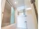 Bright bathroom showcasing a glass-enclosed shower/tub and a single sink vanity at 240 Sand Key Estates Dr # 243, Clearwater Beach, FL 33767