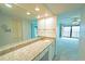 Bathroom with a granite countertop vanity and a bathtub with glass doors at 240 Sand Key Estates Dr # 243, Clearwater Beach, FL 33767
