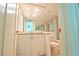 Bright bathroom vanity with granite countertops, cabinets, and a shower-tub combo at 240 Sand Key Estates Dr # 243, Clearwater Beach, FL 33767