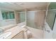Bathroom featuring vanity with granite counters and a shower/tub combo with glass doors at 240 Sand Key Estates Dr # 243, Clearwater Beach, FL 33767
