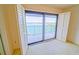 This bedroom has ample natural light and a sliding glass door leading to a balcony with a water view at 240 Sand Key Estates Dr # 243, Clearwater Beach, FL 33767